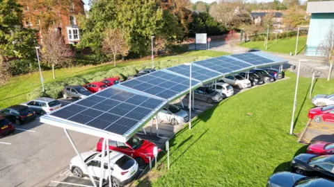 A solar canopy covering cars in a car park.