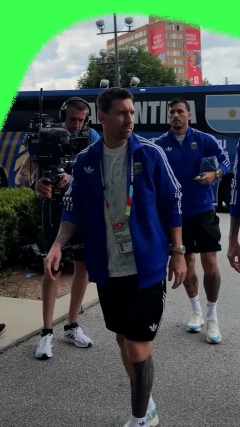 Lionel Messi in a blue jacket and black shorts as he arrives in the Atlanta Stadium for England v Argentina