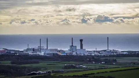 PA Media Large industrial buildings at Sellafield with the sea beyond