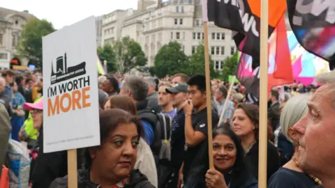 LDRS Protesters holding placards calling for Birmingham City Council staff in female-dominated roles to be paid the same as those in male-dominated roles