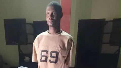 Arrested Nigerian Army Private Mohammed Yusuf wearing a T shirt with 69 written on it