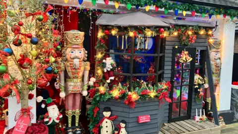 A selection of Christmas decorations standing outside the house.