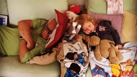 Heavy, sleeping on couch, with his granddaughter, Ellie Skye, in 2013