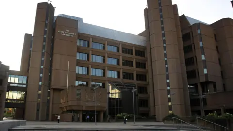 PA Media Liverpool Crown Court, which is a brown concrete multi-storey structure with a glass reception area.