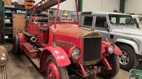 Karl Bird/BBC A vintage red fire engine with ladder and hand-rung bell 