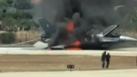 A Hellenic Air Force F-16 fighter jet on fire after crash-landing at Zakynthos airport, Greece. Screenshot from a video on 9 July 2026.