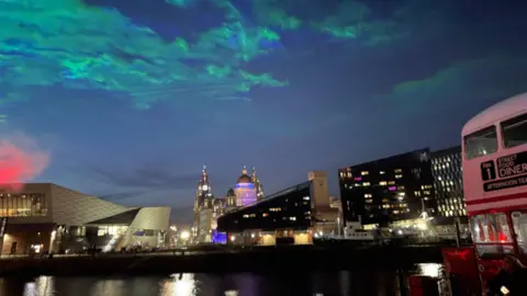 Waves of green lights in night sky above the Pier Head, as seen from the Albert Dock