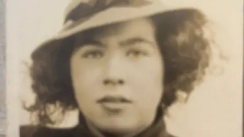 close up picture of Betty as a teenager wearing a hat
