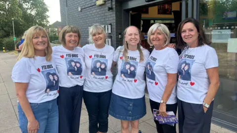 Left to right: Andrea Jack, Haidee Haines, Sue Dawson, Karen Pitt, Elaine Allcock Michelle West. The women are wearing matching white t-shirts with a picture of Geraldine on the front.