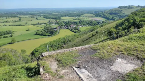 A piece of overgrown concrete on top of a hill