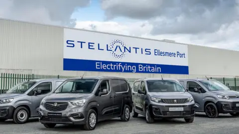 Getty Images A series of electric cars outside Stellantis's factory in Ellesmere Port