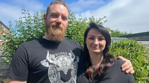 James Carter and Stephanie Weeding. James has a beard and short brown hair. Stephanie has long dark hair.