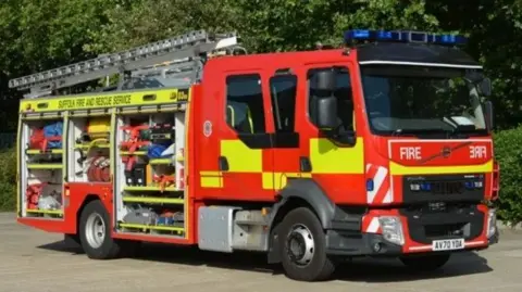 A fire engine with the side open and ladder on top