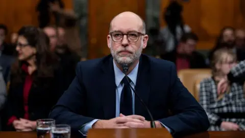 Getty Images Vought with his hands folded during a senate confirmation hearing 