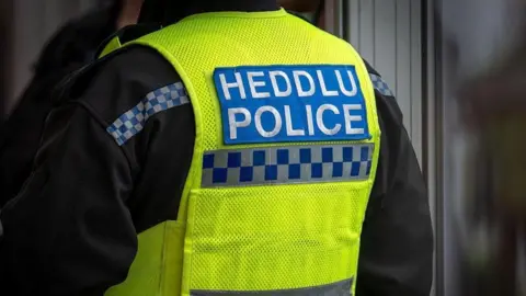 Getty Back of a Welsh police officer in uniform.