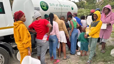 People queuing with buckets to get water from a Gift for Givers tanker