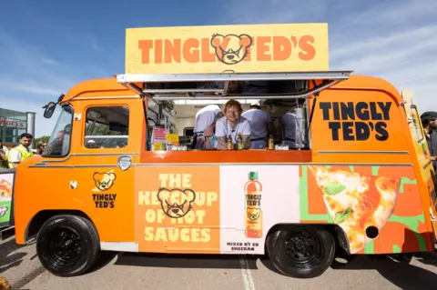 PA Media Ed Sheeran inside food van with 'Tingly Ted's' sign