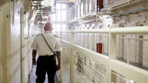 A prison officer walks through HMP Barlinnie in Scotland