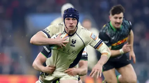 Joe Owen tries to break free of a tackle