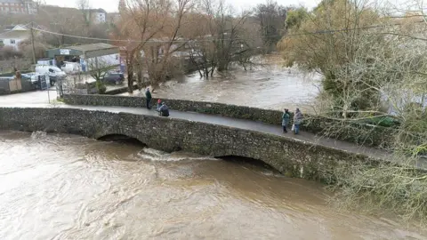 Aerial view the River Axe seen in floods during Storm Chandra.