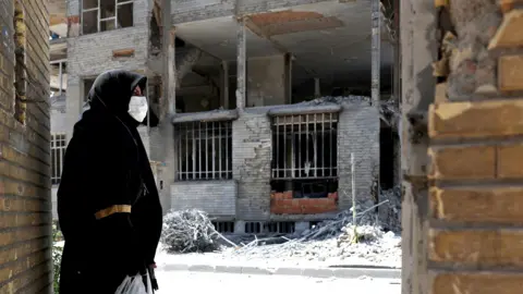 A woman looks at the rubble of her house, which was damaged in a U.S. and Israeli strike in March, in Tehran, Iran June 7, 2026