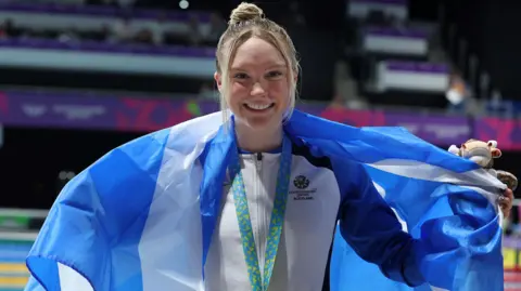 Toni Shaw with a Scotland flag draped around her neck