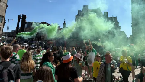 Celtic fans let off smoke bombs after gathering in the Trongate area after the match