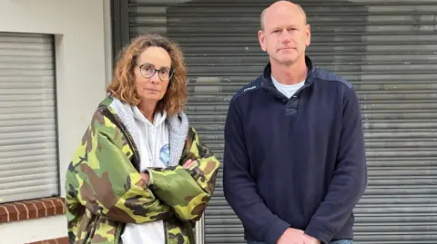 BBC/JULIA GREGORY Ali Pereira and Dr Thom Vanevery standing outside the Guildford Lido.
