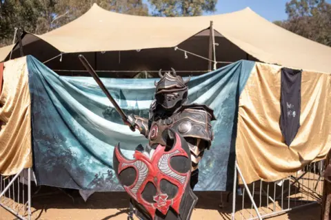  EMMANUEL CROSET / AFP  A cosplayer poses for a portrait at the medieval fantasy fair in Benoni, near Johannesburg on August 10, 2024.