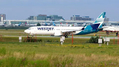A WestJet plane taxis for departure at Toronto Pearson International Airport in Mississauga, Ontario, in July 2026