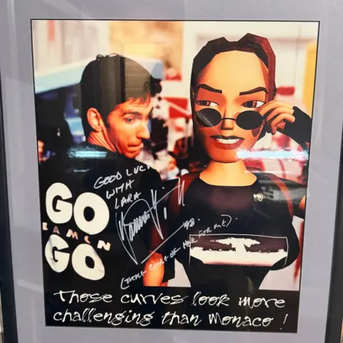 A Lara Croft Formula 1 advert saying she has curves more dangerous than Monaco