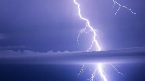 Gardener Patrick/Weather Watchers Lightning strike across a dark sky. 