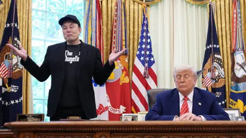 Tesla CEO Elon Musk speaks alongside U.S. President Donald Trump to reporters in the Oval Office of the White House on May 30, 2025 in Washington, DC. Musk, who served as an adviser to Trump and led the Department of Government Efficiency, announced he would leave his role in the Trump administration to refocus on his businesses.