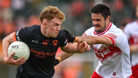 Armagh goal-scorer Conor Turbitt is tackled by Derry full-back Chrissy McKaigue