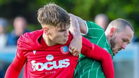 Rhys Murphy of Yeovil Town and Joe Rye of Worthing FC jostle for the ball