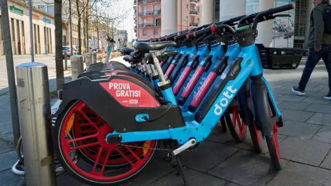 A row of blue Dott bikes