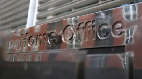 Exterior shot of a 'Home Office' sign.