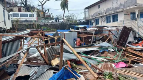 Getty Images This photo shows a pile of metal and wood fragments after storm Chido hit the French Indian Ocean territory of Mayotte, on December 14, 2024 in the capital Mamoudzou