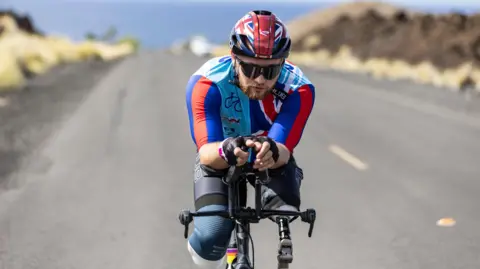 Comic Relief Billy Monger riding the 140-mile bike section of the Ironman in Kona, Hawaii