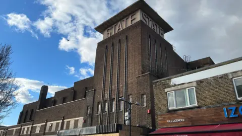 An old building with State written on the top of the building