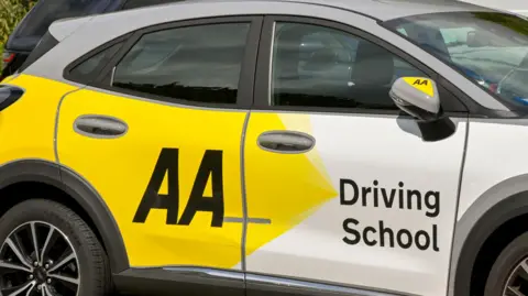  Side view of a driving school car operated by the AA Automobile Association.