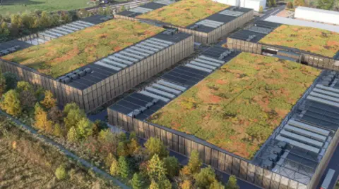 Four large square buildings with green roofs and surrounded by trees