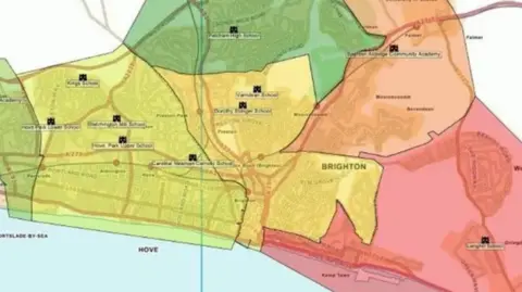Local Democracy Reporting Service A map showing the proposed new catchment areas for secondary schools in Brighton and Hove; the city region is divided into colour coded sections. East of the city is red, north east is orange, north is green, the central area is yellow and two sections further west are different shades of green.