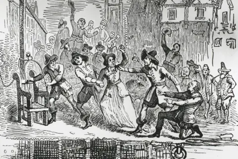 Hulton Archive/Getty Images A black and white line drawing showing two men dragging a woman towards a chair attached to a post on the bank of a body of water. Other figures watch and cheer. The people are wearing 17th century-style clothes and buildings of the period can be seen.