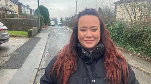 Photograph of Stacey Taylor from Tonge Fold in Bolton. She is pictured on a road in the Breightmet area of the town.