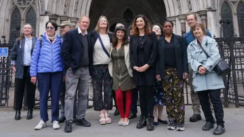Rebekah Shaman, from the Protect Brockwell Park Group, stands with others male and female residents outside the Royal Courts of Justice.