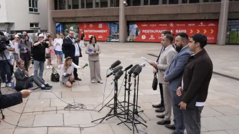 PA Muhammad Amaad (second right) outside Liverpool Crown Court.