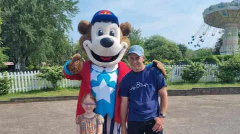 Suzi Russell A man and a child with a mascot