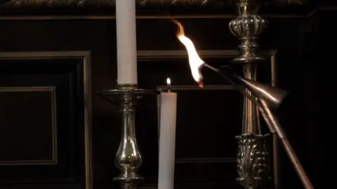 David Panos/NN Contemporary Art Candle being lit