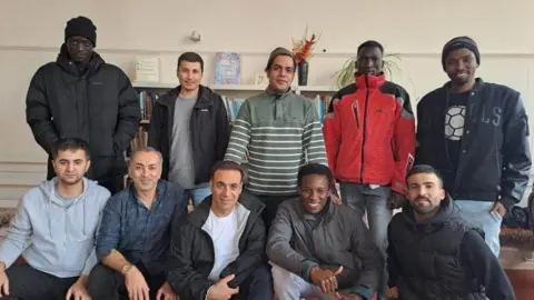 BBC Asylum seekers posing for a photo